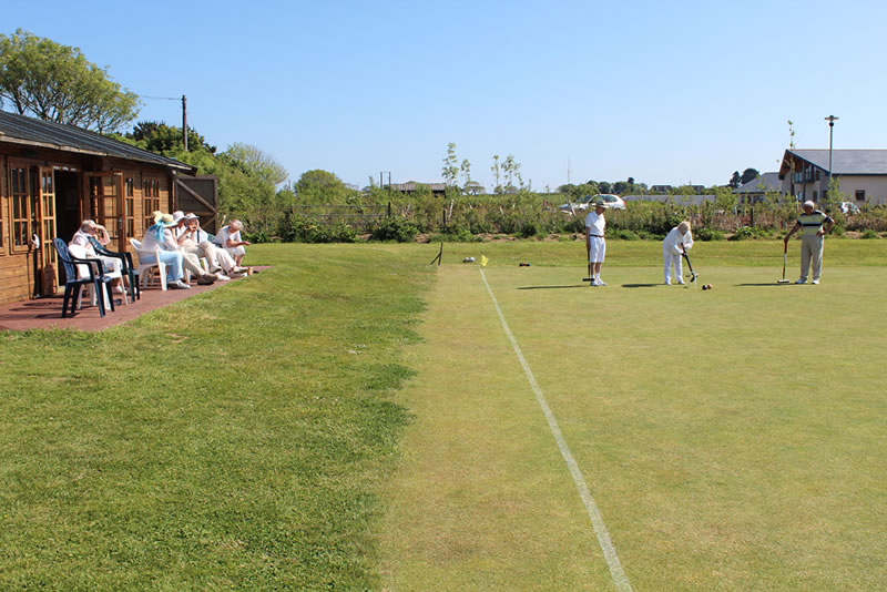 Members enjoying lovely sunny day of croquet